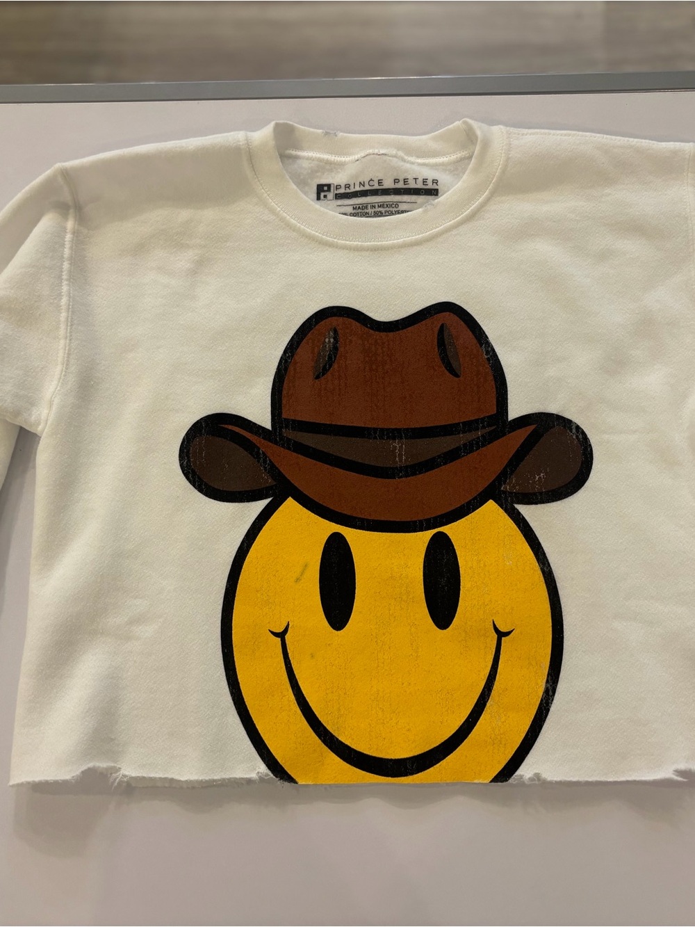 Prince Peter Collection Cream Sweatshirt with Yellow Smiley Cowboy Graphic